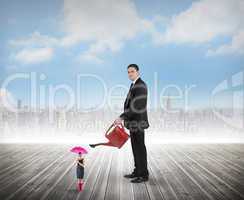 Composite image of businessman watering tiny businesswoman