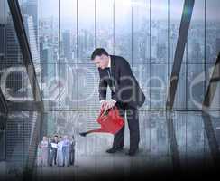 Composite image of mature businessman watering tiny business tea