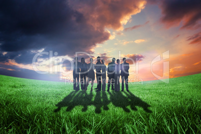 Composite image of business team looking at camera