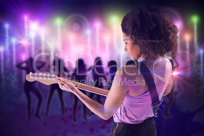 Composite image of pretty girl playing guitar