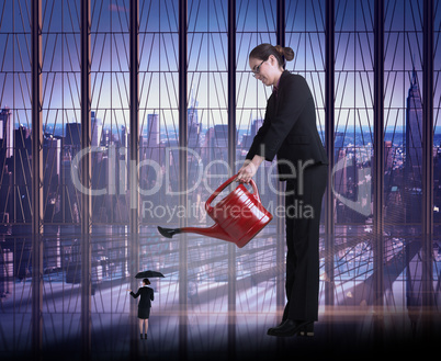 Composite image of businesswoman watering tiny business woman