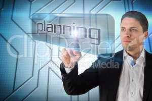 Businessman pointing to word planning