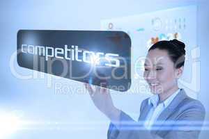 Businesswoman pointing to word competitors