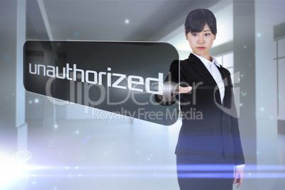 Businesswoman pointing to word unauthorized