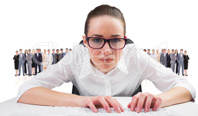 Composite image of businesswoman typing on a keyboard