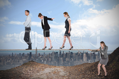 Young businesswoman pulling a tightrope for business people