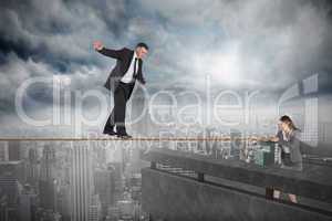 Young businesswoman pulling a tightrope for businessman