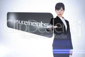 Businesswoman pointing to word measurements