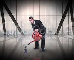 Composite image of businessman watering tiny businessman