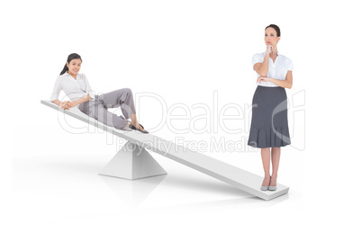 White scales measuring two businesswomen