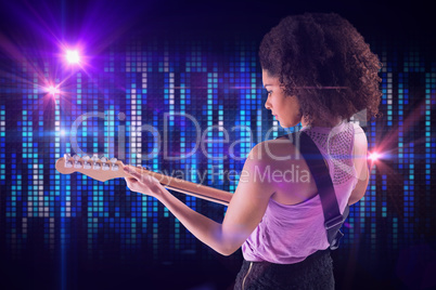 Composite image of pretty girl playing guitar