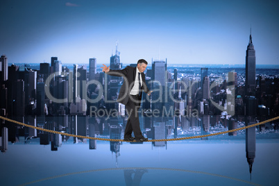 Composite image of mature businessman doing a balancing act on t