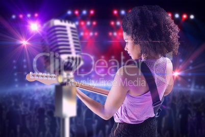 Composite image of pretty girl playing guitar