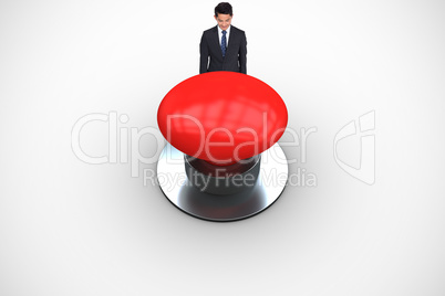 Composite image of smiling businessman looking down