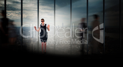 Composite image of redhead businesswoman in a blindfold