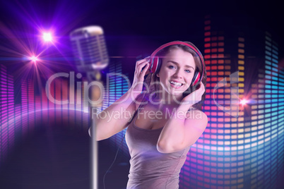 Composite image of pretty girl listening to music