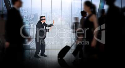 Composite image of mature businessman in a blindfold