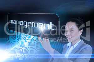 Businesswoman pointing to word management