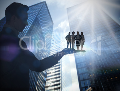 Composite image of businessman holding business team