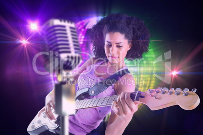 Composite image of pretty girl playing guitar