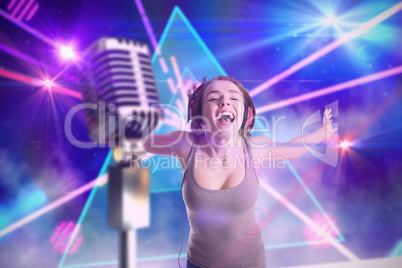 Composite image of pretty girl listening to music