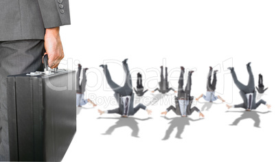 Composite image of businessman holding briefcase