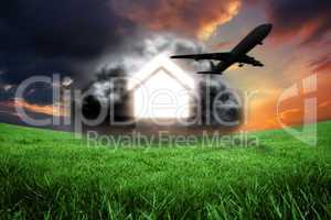 Composite image of house in grey cloud with airplane