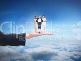 Composite image of team of businesswomen looking at camera