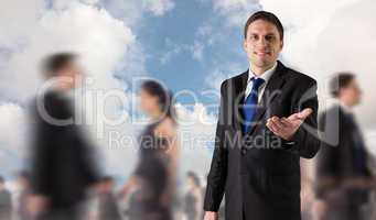 Composite image of handsome businessman holding hand out