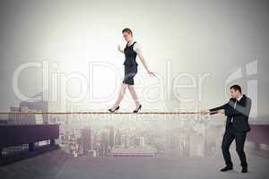 Young business man pulling a tightrope for businesswoman