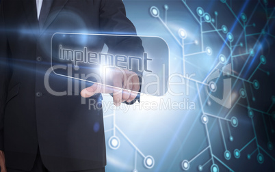 Businessman pointing to word implement