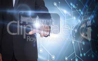 Businessman pointing to word implement