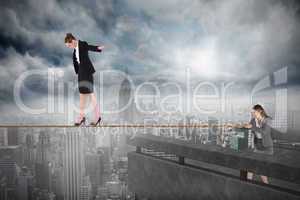 Young business woman pulling a tightrope for businesswoman