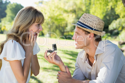 Man surprising his girlfriend with a proposal in the park