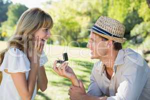 Man surprising his girlfriend with a proposal in the park