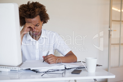 Casual stressed businessman working at his desk