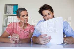 Casual business team working at desk reading document