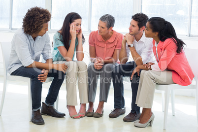 Group therapy in session sitting in a circle