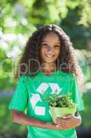 Young environmental activist smiling at the camera holding a pot
