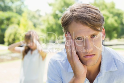 Upset man looking at camera after a fight with his girlfriend in