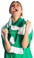 Cheering football fan in green jersey