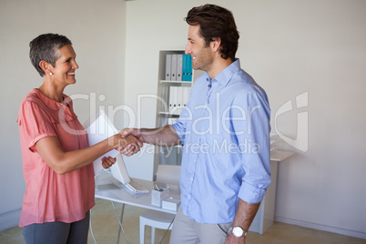 Casual smiling business people shaking hands