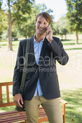 Casual businessman talking on smartphone in park