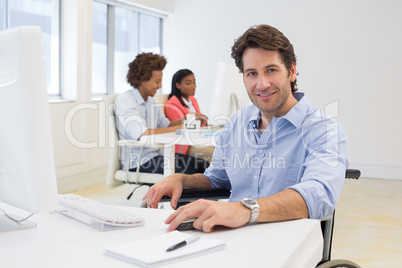 Man in wheelchair works hard looking at camera