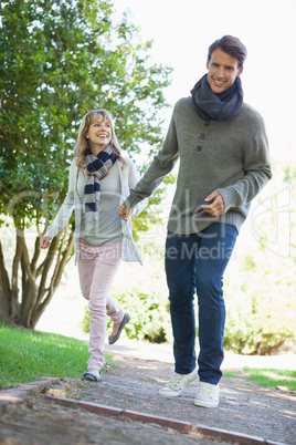 Cute couple walking hand in hand in the park