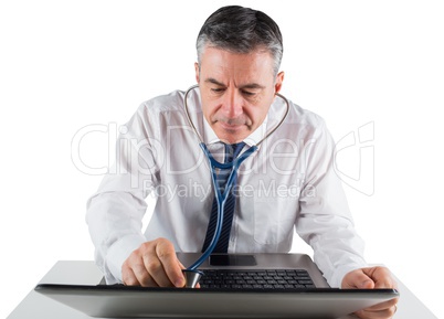 Mature businessman running diagnostics on laptop
