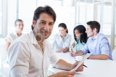 Attractive businessman smiling in the workplace