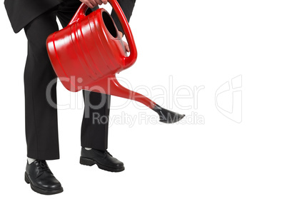 Businessman watering with red can