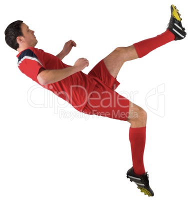 Football player in red kicking