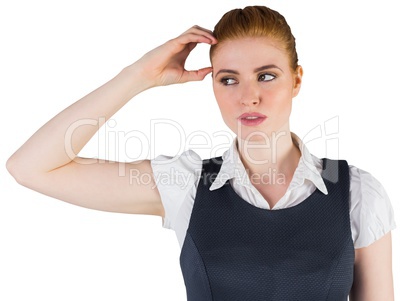 Thinking redhead businesswoman scratching head
